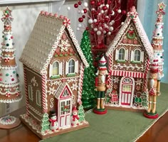 three small gingerbread houses with decorations on them