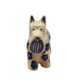 a ceramic dog figurine with blue flowers on it