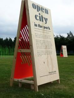 an open city sign in the park