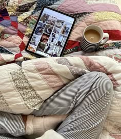 a person laying in bed next to a cup of coffee and an ipad on their lap