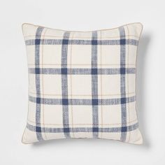 a white and blue plaid pillow on a gray background