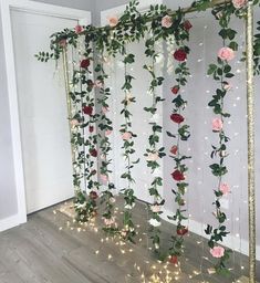 an arrangement of flowers and greenery on a wall