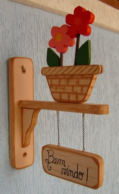 a potted plant is hanging on a wooden shelf