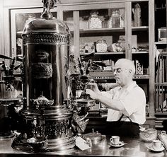 black and white photograph of a man working on a machine