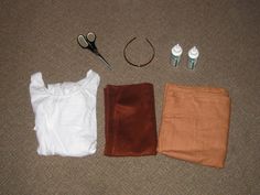 three items are laid out on the floor to be used as clothing and hair accessories