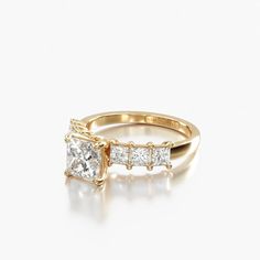 a gold ring with three princess cut diamonds