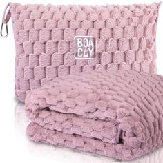 a pink blanket with the word boat clay on it and two matching pillows in front