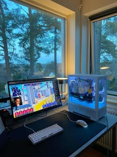 two computer monitors sitting on top of a desk next to a keyboard and monitor screen