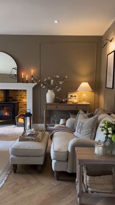 a living room filled with furniture and a fire place in the middle of the room