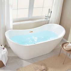 a bathroom with a bathtub and rugs on the floor