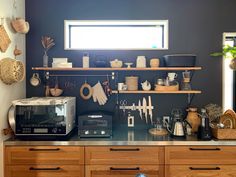 a kitchen with wooden cabinets and shelves filled with items