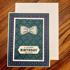 a happy birthday card with a bow tie on the front and green, purple, and white background