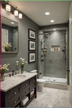 a bathroom with gray walls and white fixtures