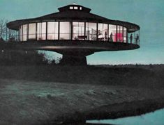 an image of a lighthouse at night with people standing on the roof and looking out over the water