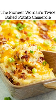 a casserole with bacon, cheese and green onions in a baking dish on a wooden spoon