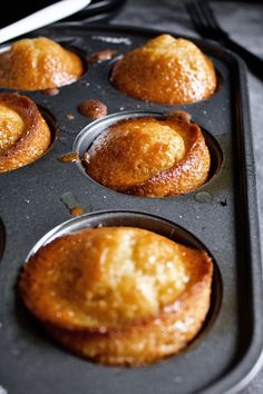 several muffins in a black tray on a counter top, ready to be baked