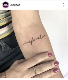 a woman's arm with the word in cursive writing on it and her hand