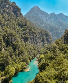 a river surrounded by trees and mountains