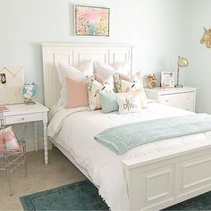 a white bed sitting in a bedroom next to a desk