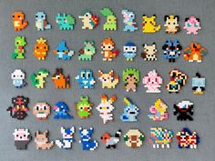 an array of pixelated video game characters are displayed on a gray surface with grey background