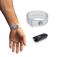 a person's arm, wristband and remote control on a white background next to an electronic device