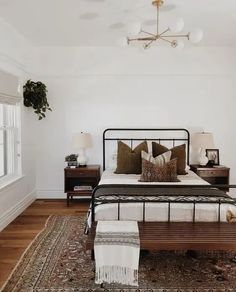 a bedroom with white walls and wooden floors