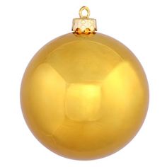 a shiny gold ball ornament on a white background