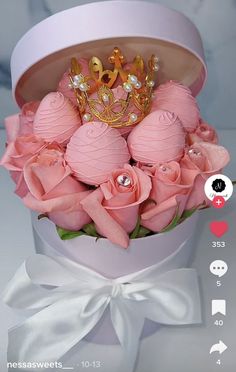 pink roses in a white box with a crown on top