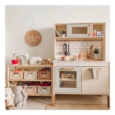 a toy kitchen with wooden shelves and drawers