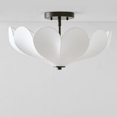 a white light fixture hanging from the ceiling