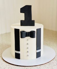 a cake with a bow tie and number one on it