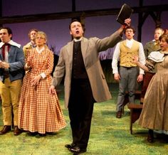 a group of people standing on top of a stage