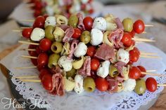 several skewered food items are displayed on a doily