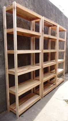 several wooden shelves lined up against a wall