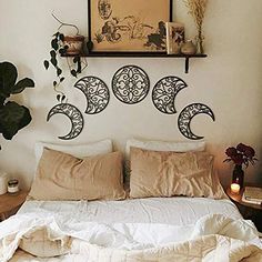 a bed topped with pillows and blankets next to a plant