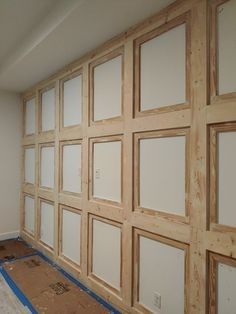 an unfinished room with wood paneling and white paint on the walls in preparation for remodeling