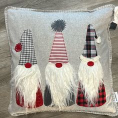 three gnomes on a gray pillow with red and white flannel trimming