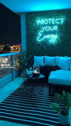 a living room filled with furniture and a neon sign