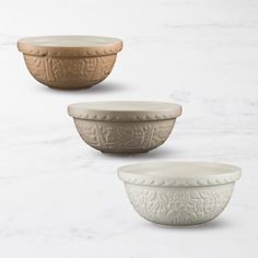 three bowls sitting on top of a white counter