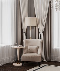 a chair sitting in front of a window next to a table with a lamp on it