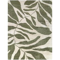 an area rug with leaves on it in green and white colors, including one large leaf