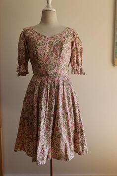 This divine vintage Laura Ashley dress is a true statement piece, made in Hungary during the 1980s. With its exquisite floral print, this dress perfectly captures the essence of spring, reminiscent of the charm and elegance of a beautiful old country house. I absolutely adore the thoughtful details--gathered fabric, delicate soft bows on each puffed sleeve, a gracefully gathered skirt, and covered buttons that add a touch of vintage romance. For convenience, the dress also features a discreet si 80s Laura Ashley Dress, Laura Ashley 80s, Laura Ashley Vintage Dress Victorian, Vintage Laura Ashley Sewing Patterns, Laura Ashley Vintage Dress 1980s, Laura Ashley Dress, Vintage Floral Dress, Vintage Romance, Gathered Skirt