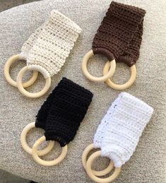 three crocheted baby toys sitting on top of a chair