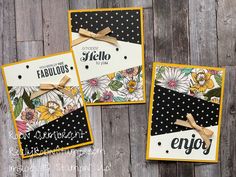 three cards with black and white designs on them, one has a yellow ribbon around it