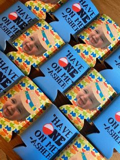 there are many blue candy boxes with pictures on the front and one has an image of a child's face