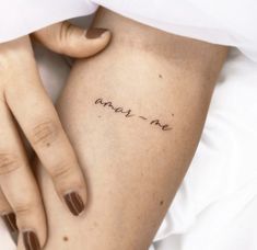 a woman's arm with writing on it that says, may i be written in cursive font