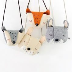 three felt animal ornaments hanging from strings