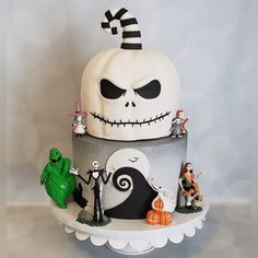 a three tiered cake decorated with halloween decorations