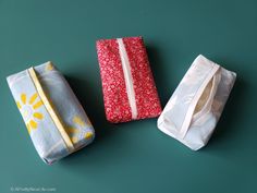 three different types of cloths on a green surface with one folded and the other rolled up