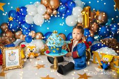 a baby is sitting in front of a cake